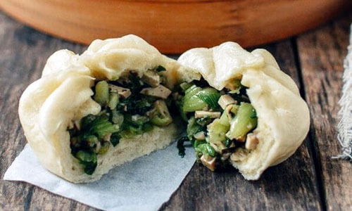 Soft steamed buns filled with warm cooked mushrooms and tofu